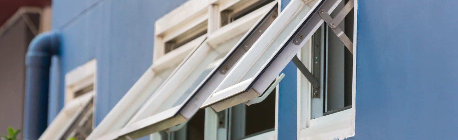 Awning windows installed above stationary windows in Milwaukee, WI home”