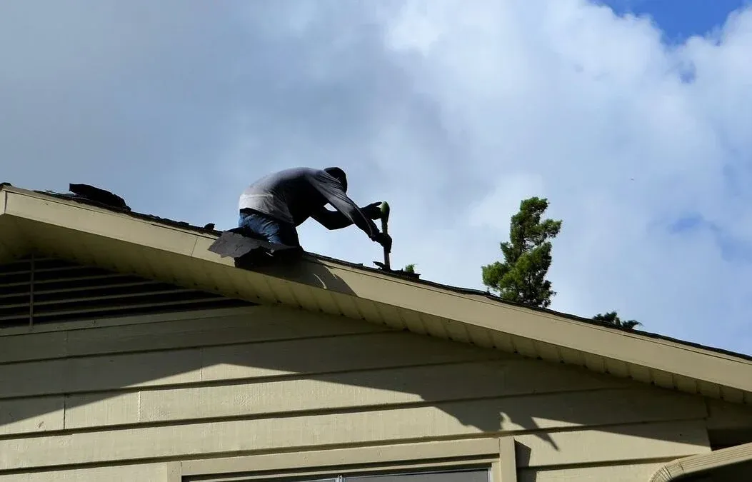 Roofing contractor discussing project details with homeowner in Milwaukee, WI, for safe and reliable roof installation